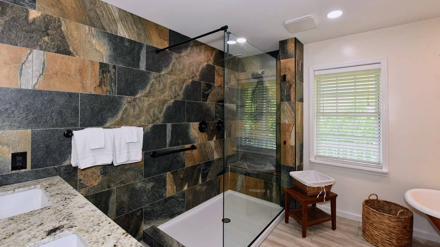 Hawk's Crest Landing I — master bathroom slate tile walk-in shower with glass enclosure and granite vanity