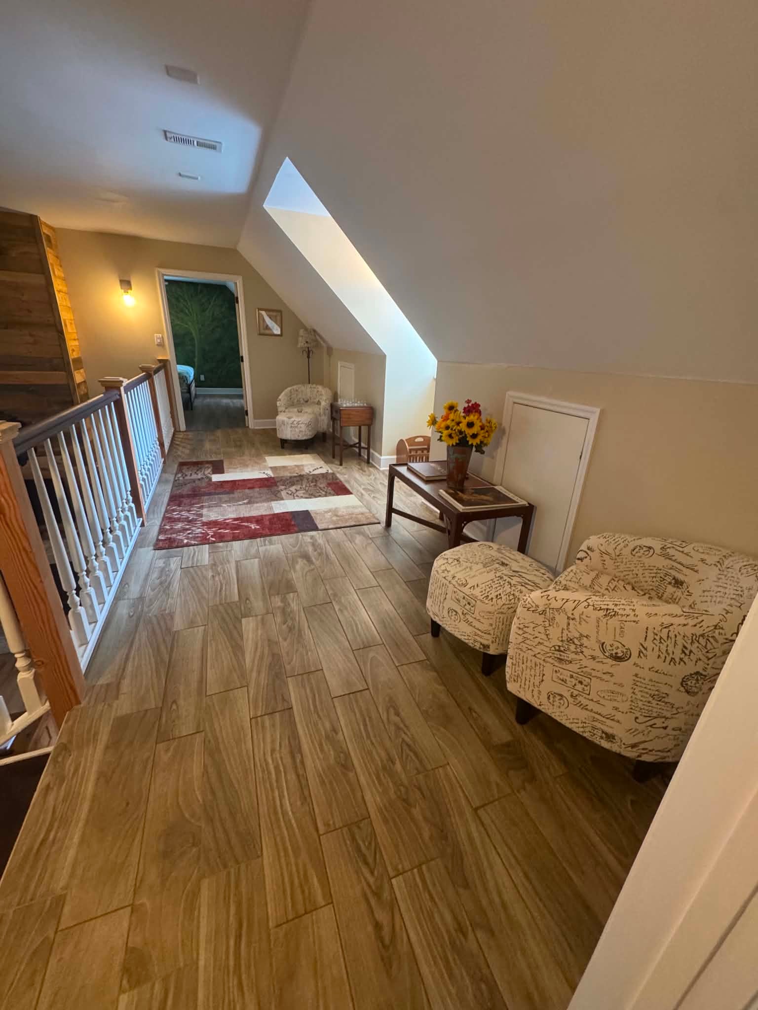 Hawk's Crest Landing I — upstairs hallway with skylight, wood floors, and sitting area